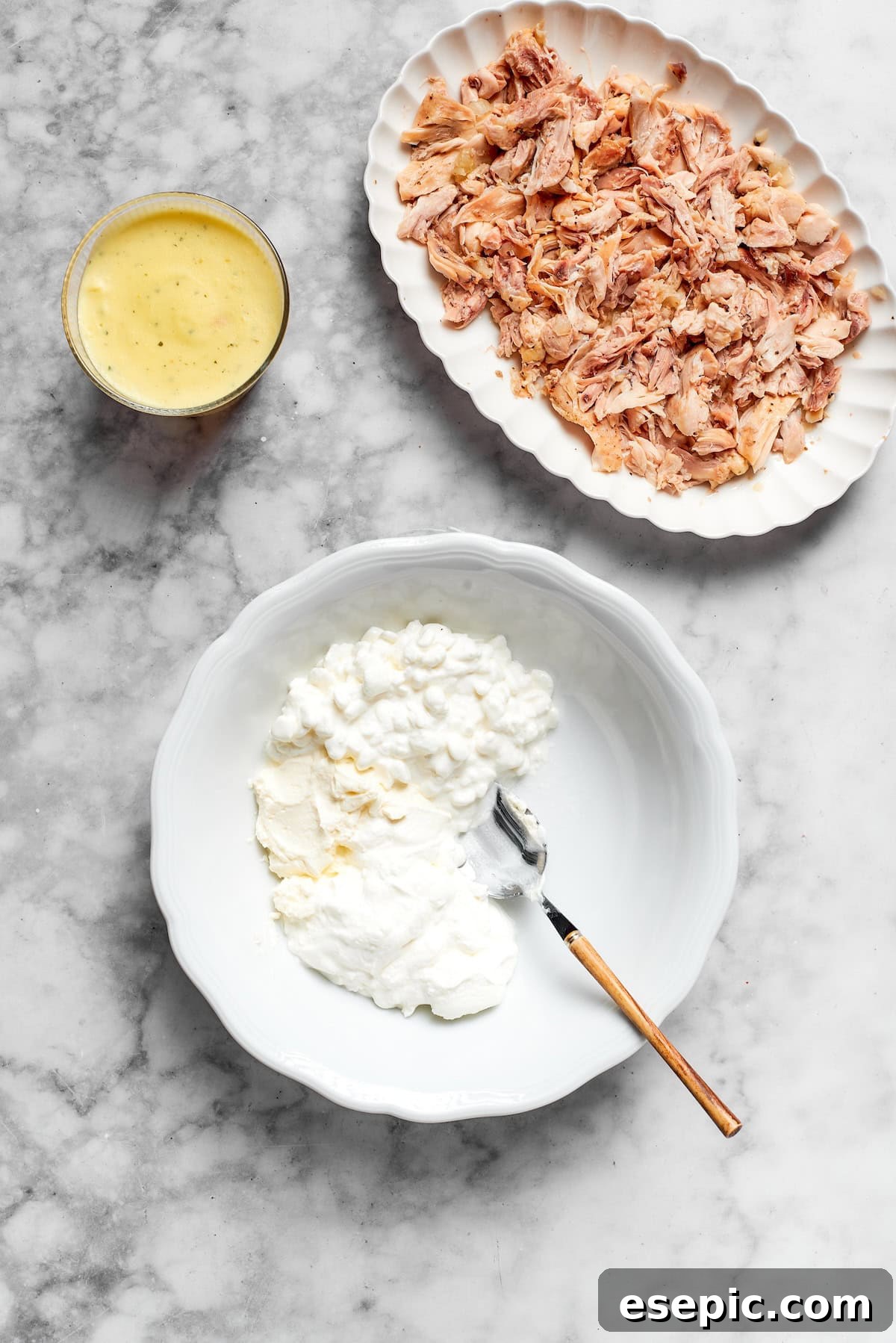 A bowl of creamy mixture, illustrating the initial steps of combining wet ingredients for the casserole.