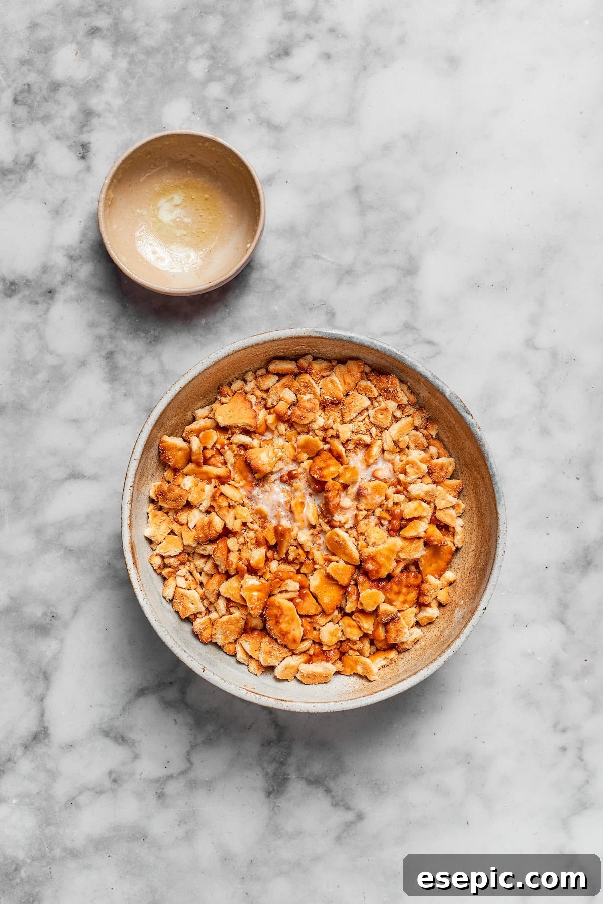 Crushed Ritz crackers mixed with melted butter in a bowl, forming the casserole topping.