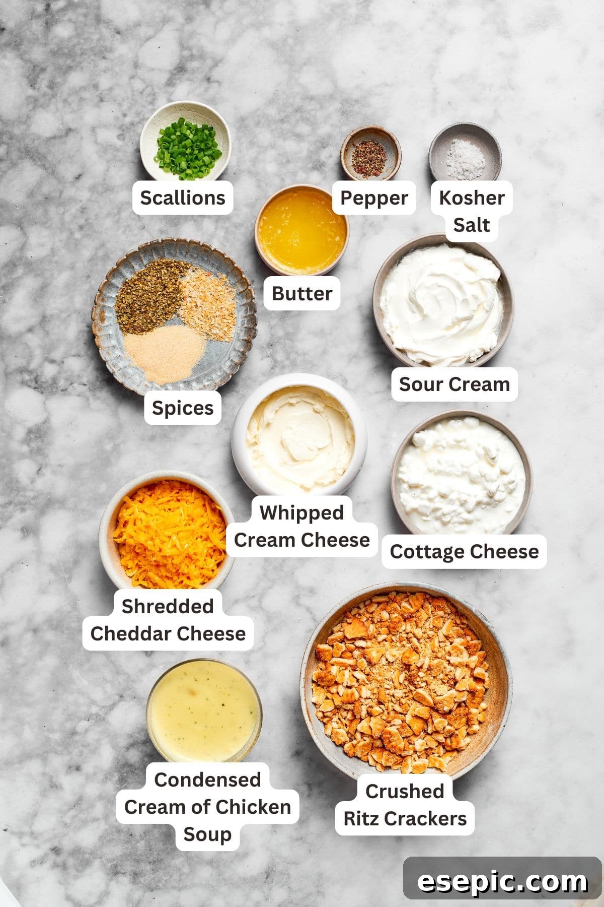 Filling ingredients for Million Dollar Chicken Casserole arranged on a surface, including cream cheese, sour cream, and spices.