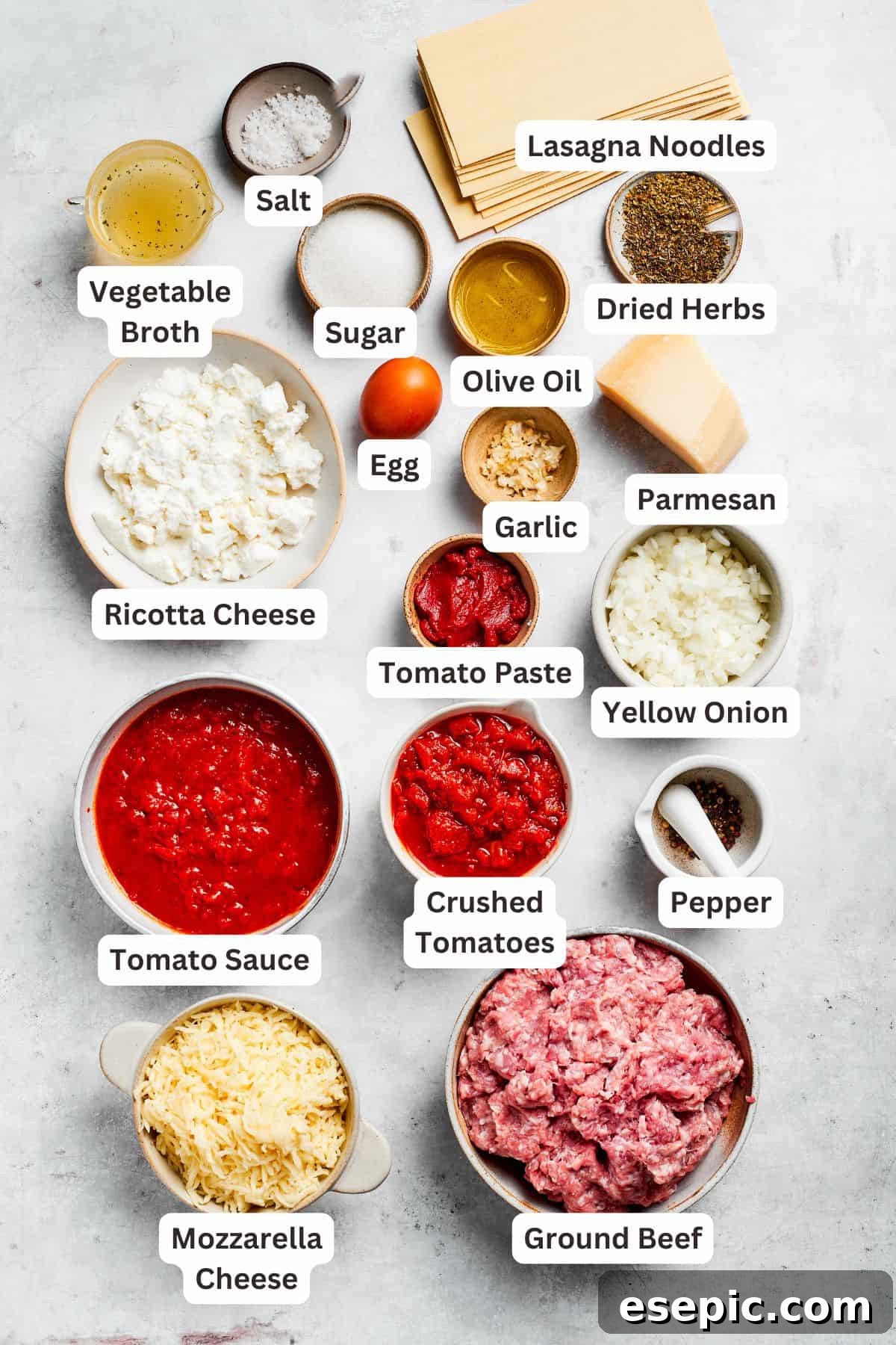 The best beef lasagna recipe is packed with tons of meaty, cheesy flavor and a rich and savory sauce. Make ahead friendly! Ingredients for beef lasagna are text-labeled, showing fresh produce and pantry staples.