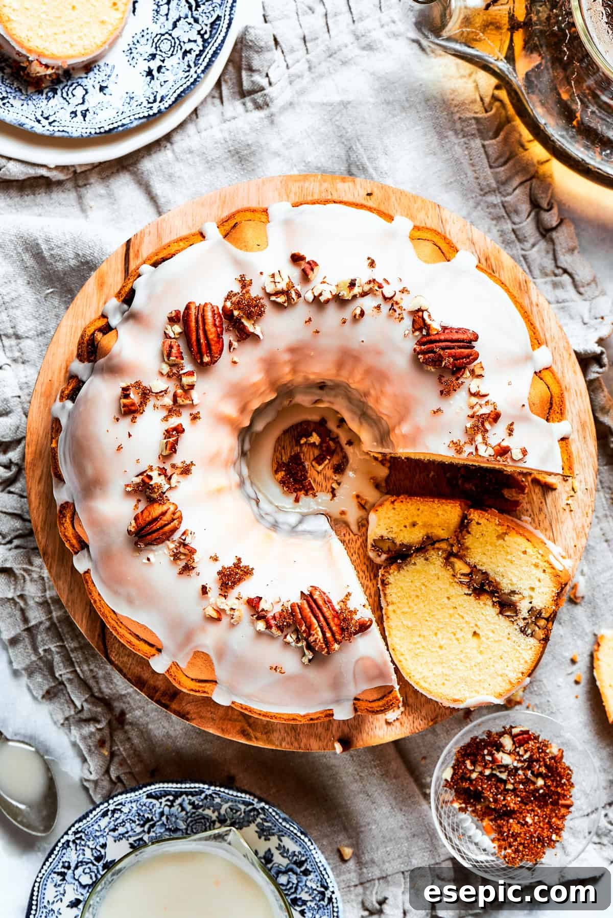 Overhead shot of a glazed sock it to me cake topped with pecans, ready to be sliced.