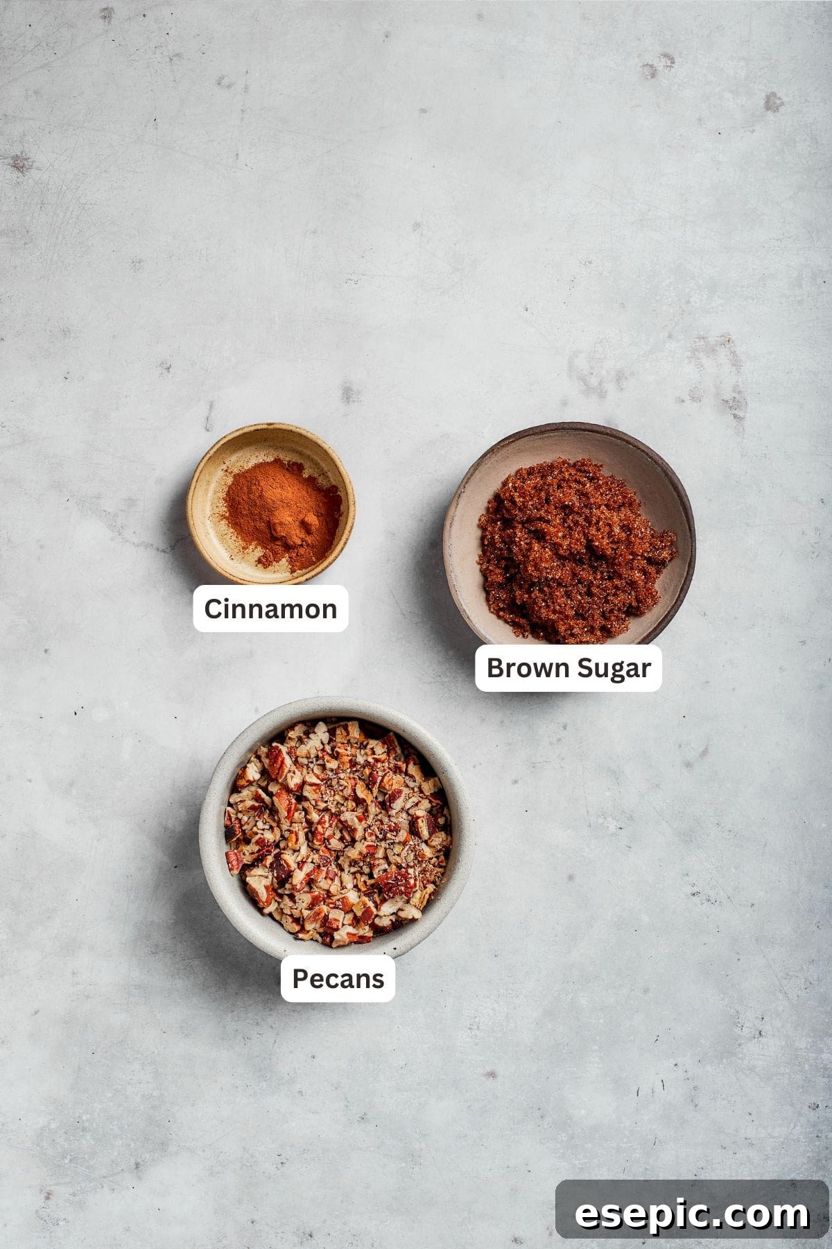 Filling ingredients for sock it to me cake text-labeled, showing chopped toasted pecans, brown sugar, and cinnamon.
