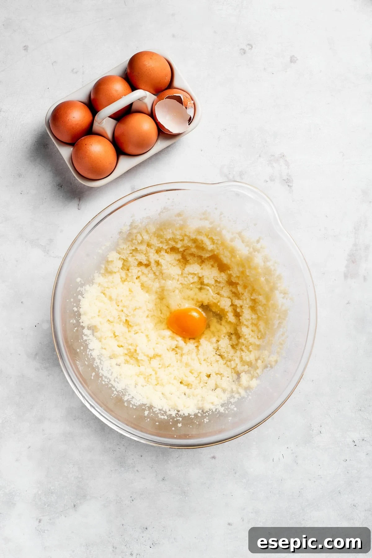 An easy recipe for Sock It To Me Cake, a tender coffee cake with a ribbon of brown sugar, cinnamon and toasted pecans through the center. Eggs are added to creamed butter and sugar.
