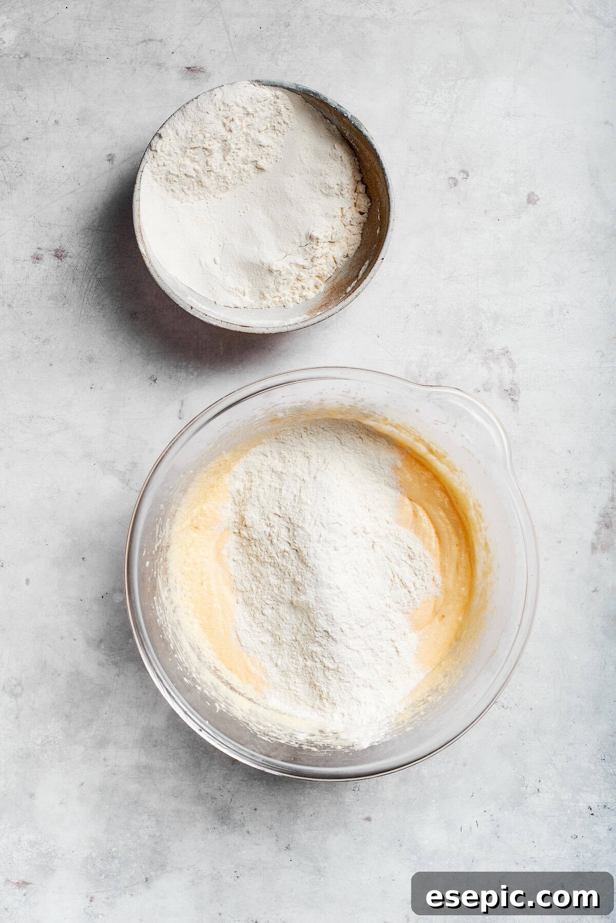 An easy recipe for Sock It To Me Cake, a tender coffee cake with a ribbon of brown sugar, cinnamon and toasted pecans through the center. Flour mix is added to sock it to me cake batter.