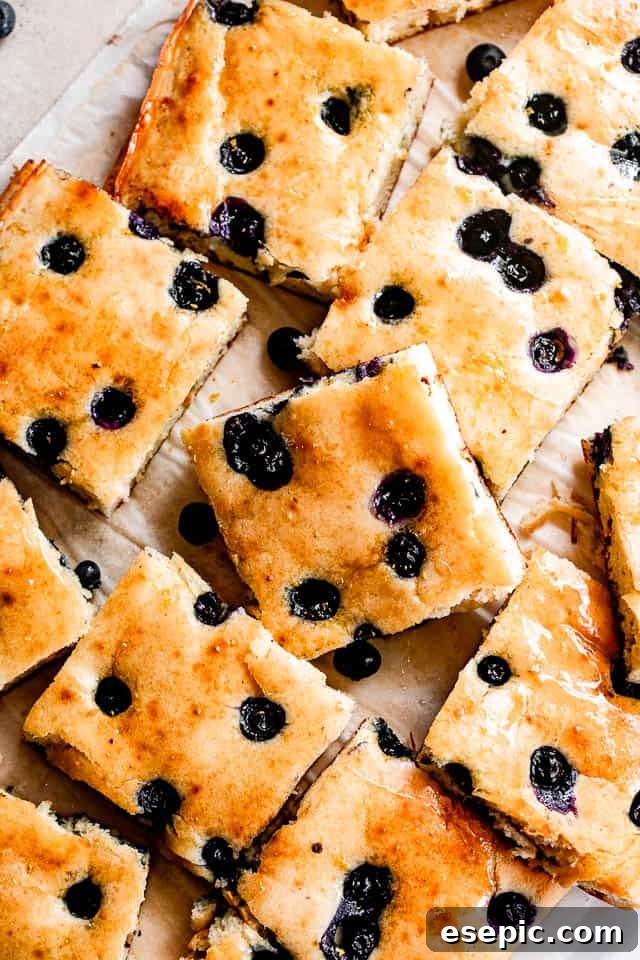 sheet pan pancakes topped with blueberries and cut into squares
