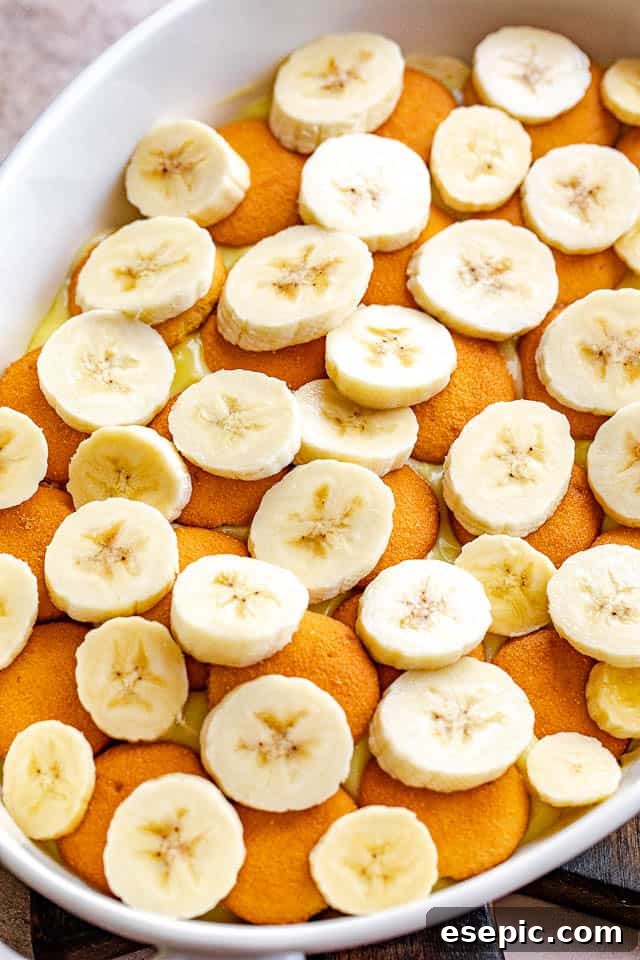 layered vanilla wafers and banana slices in a white baking dish