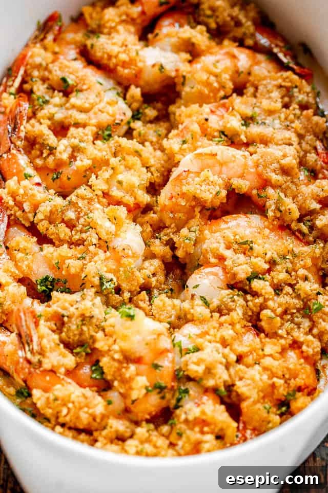 Baked shrimp in a white oval dish.