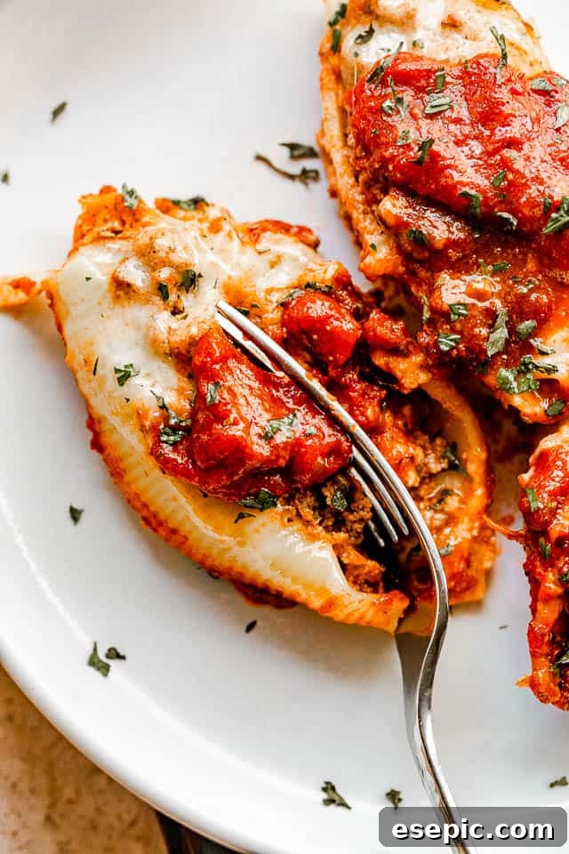 cutting into stuffed pasta shells with a fork