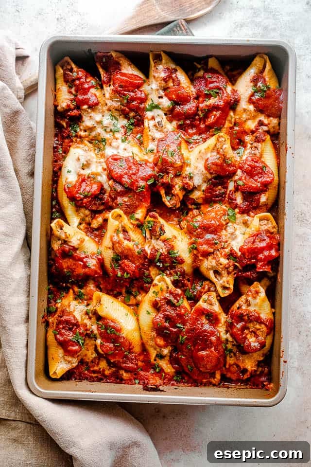 overhead shot of baked pasta shells stuffed with lasagna mixture of beef and cheese.