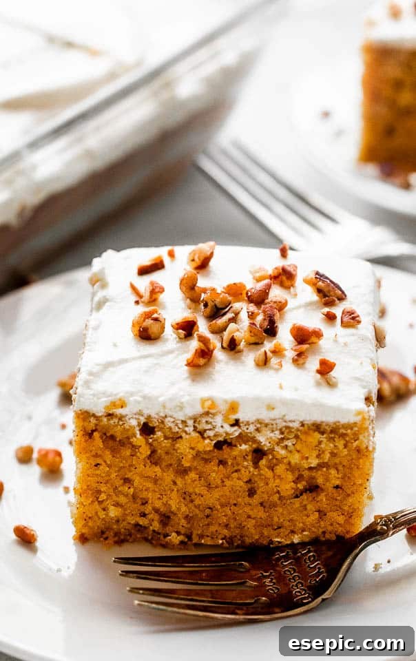 pumpkin bar slice topped with cream cheese frosting a chopped pecans