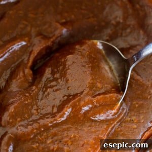 Mixing through Apple Butter with silver spoon