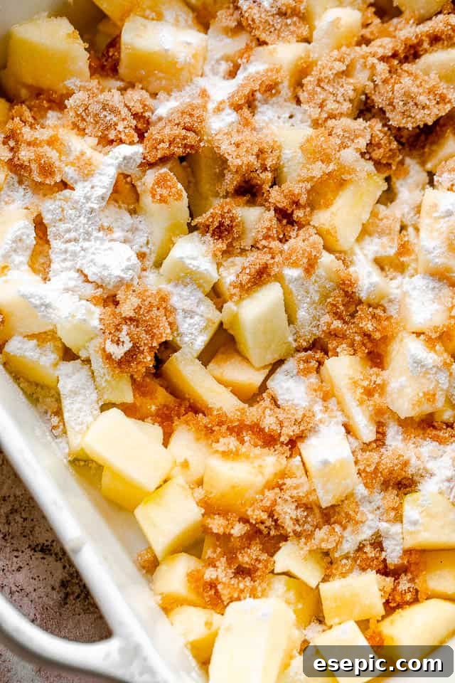S'mores-Inspired Apple Crumble 4 Close-up of freshly diced apples, lightly coated with brown sugar and flour, in a bowl, ready for the apple crumble filling.