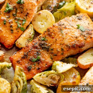 overhead shot of roasted salmon fillets with brussel sprouts and yellow squash