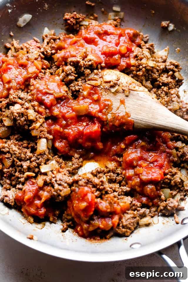 overhead shot of preparing ground beef with salsa in a skillet