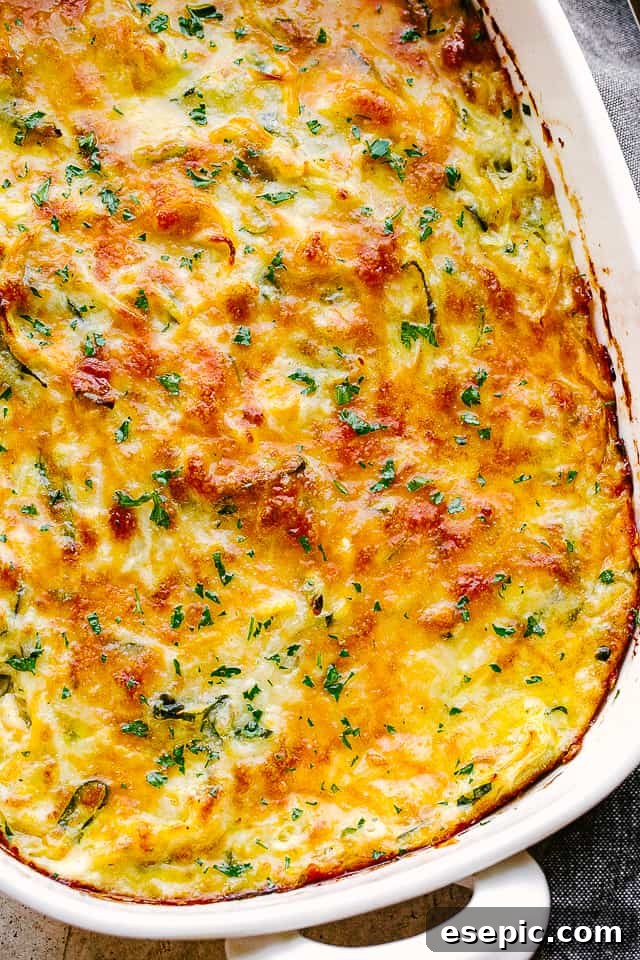 Golden Zucchini Squash Gratin 5 Close-up overhead shot of a baked zucchini squash casserole with melted cheese and golden panko topping