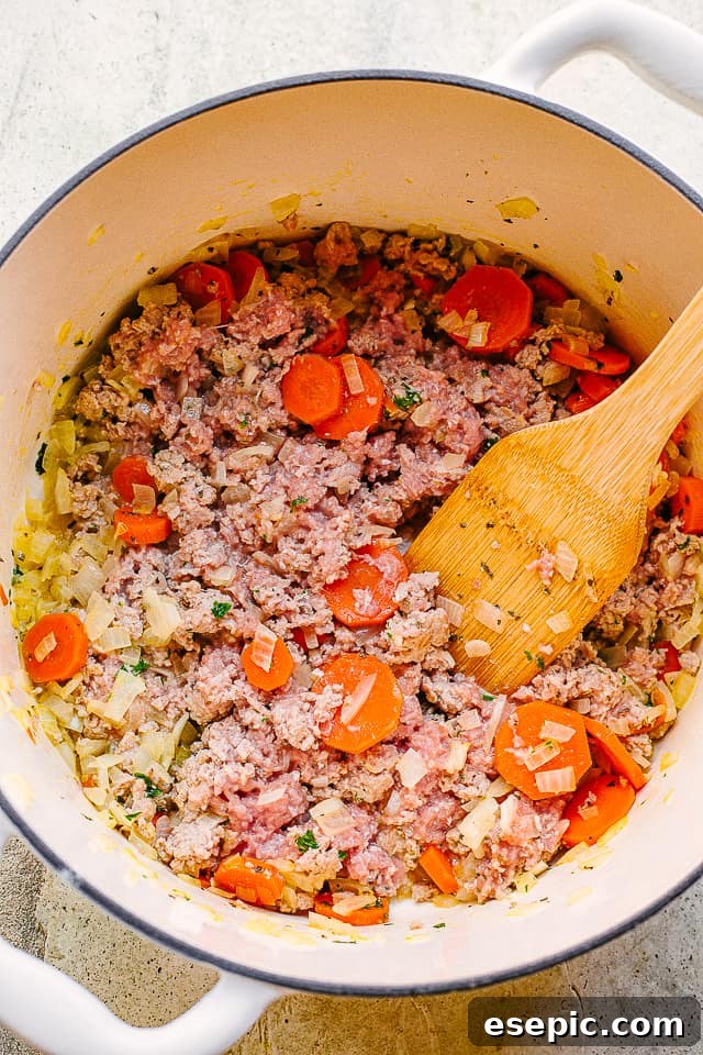 A vibrant collection of ingredients laid out, including fresh cheese ravioli, ground turkey, diced vegetables, herbs, and dairy, all ready for the creamy ravioli soup.
