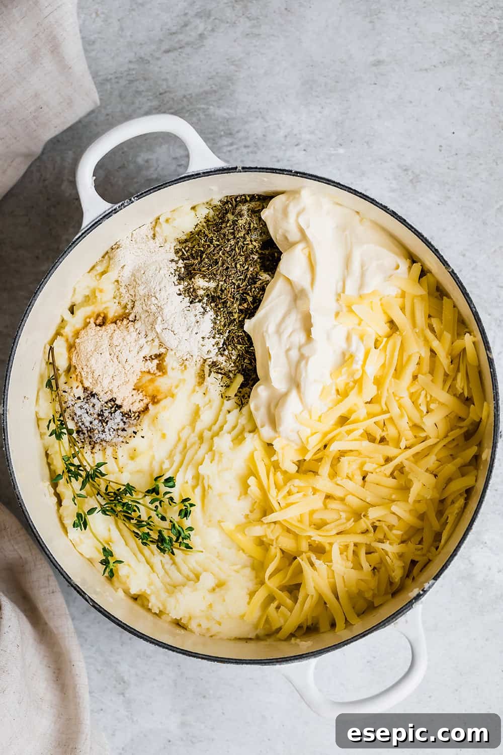 Ingredients for baked mashed potatoes in a pot ready to mix.