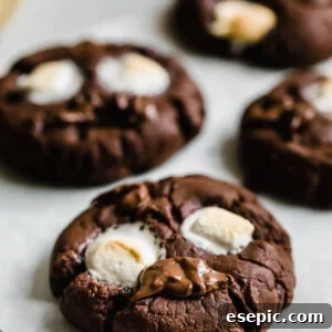 Four Chocolate Marshmallow Cookies on a Sheet of Parchment