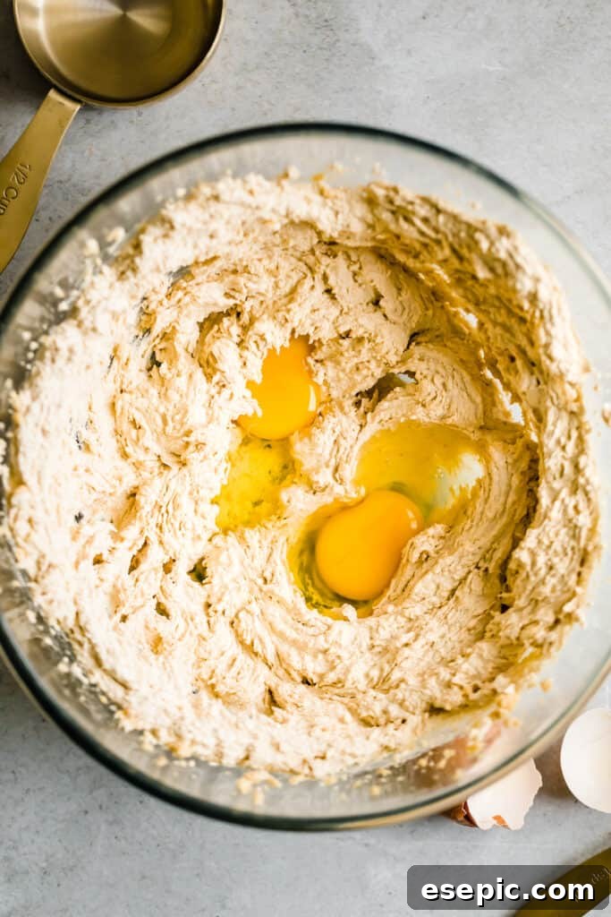 Cozy Cocoa Sugar Cookies 7 Cookie batter and eggs in a glass mixing bowl, ready to be combined.