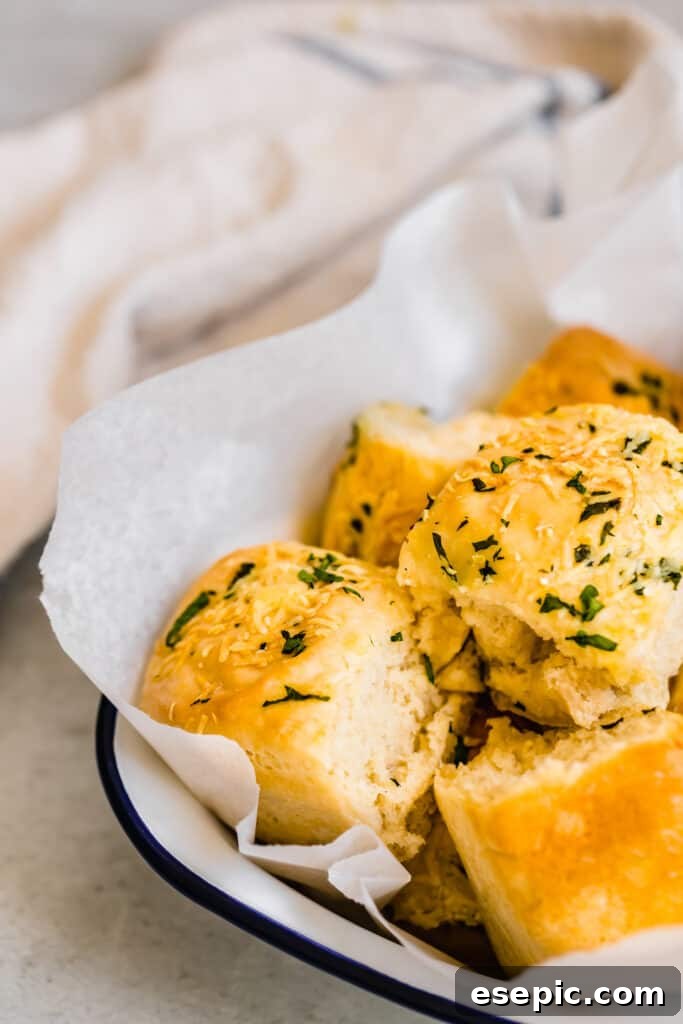 Parmesan Dinner Rolls Inside of a Serving Dish in Front of a White Towel