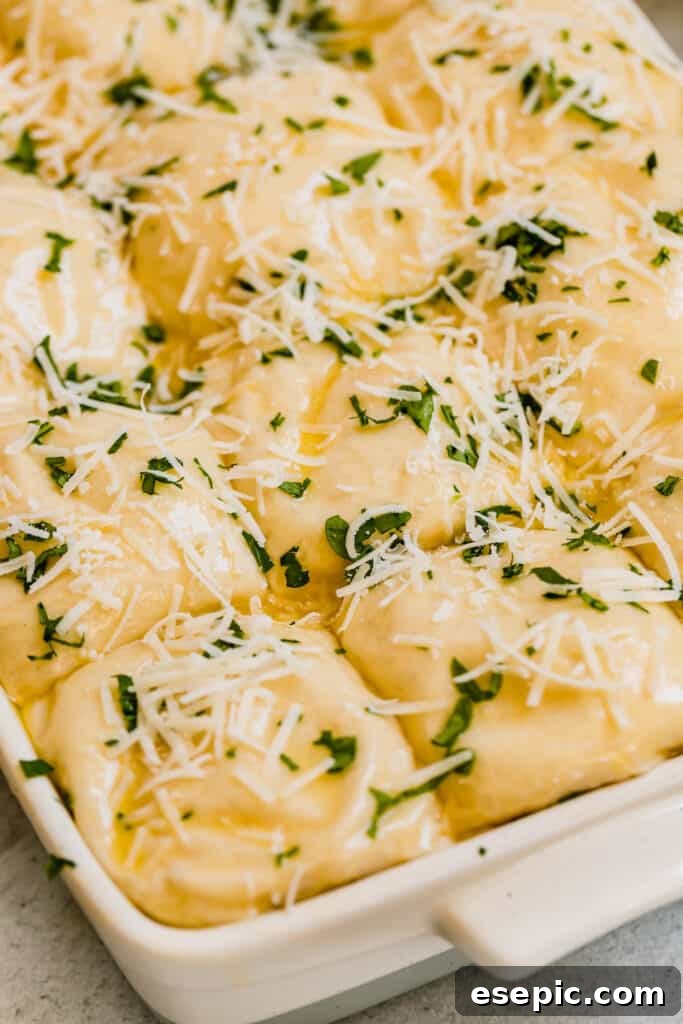Oven-Ready Parmesan Dinner Roll Dough in an Off-White Pan