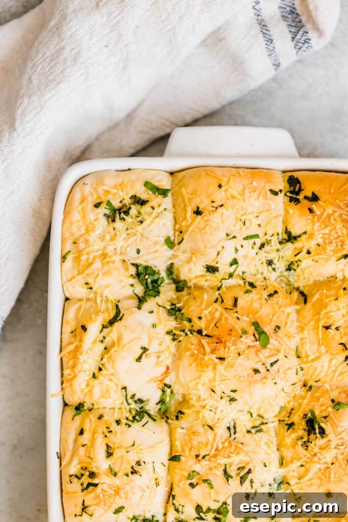 A Pan Full of Baked Dinner Rolls With Parmesan & Parsley