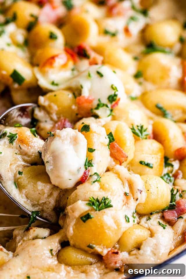 Golden Gnocchi and Crispy Bacon Bake 3 Up close shot of a spoonful of creamy gnocchi and bacon casserole, highlighting the texture and sauce