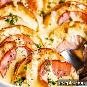 spooning out eggs benedict casserole from a casserole dish