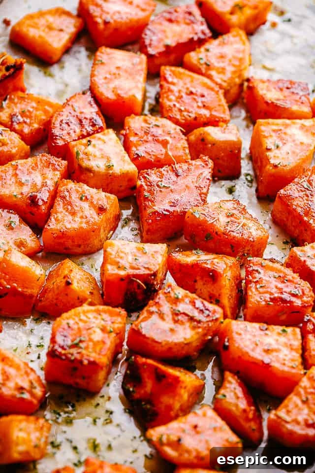 Serving Garlic Honey Roasted Sweet Potatoes Close-up overhead shot of a vibrant platter of garlic honey roasted sweet potatoes, garnished with fresh herbs, ready to be served.