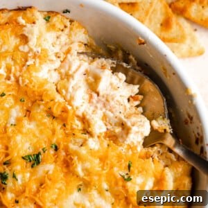 Close up shot of a spoon in a baking dish with hot crab dip