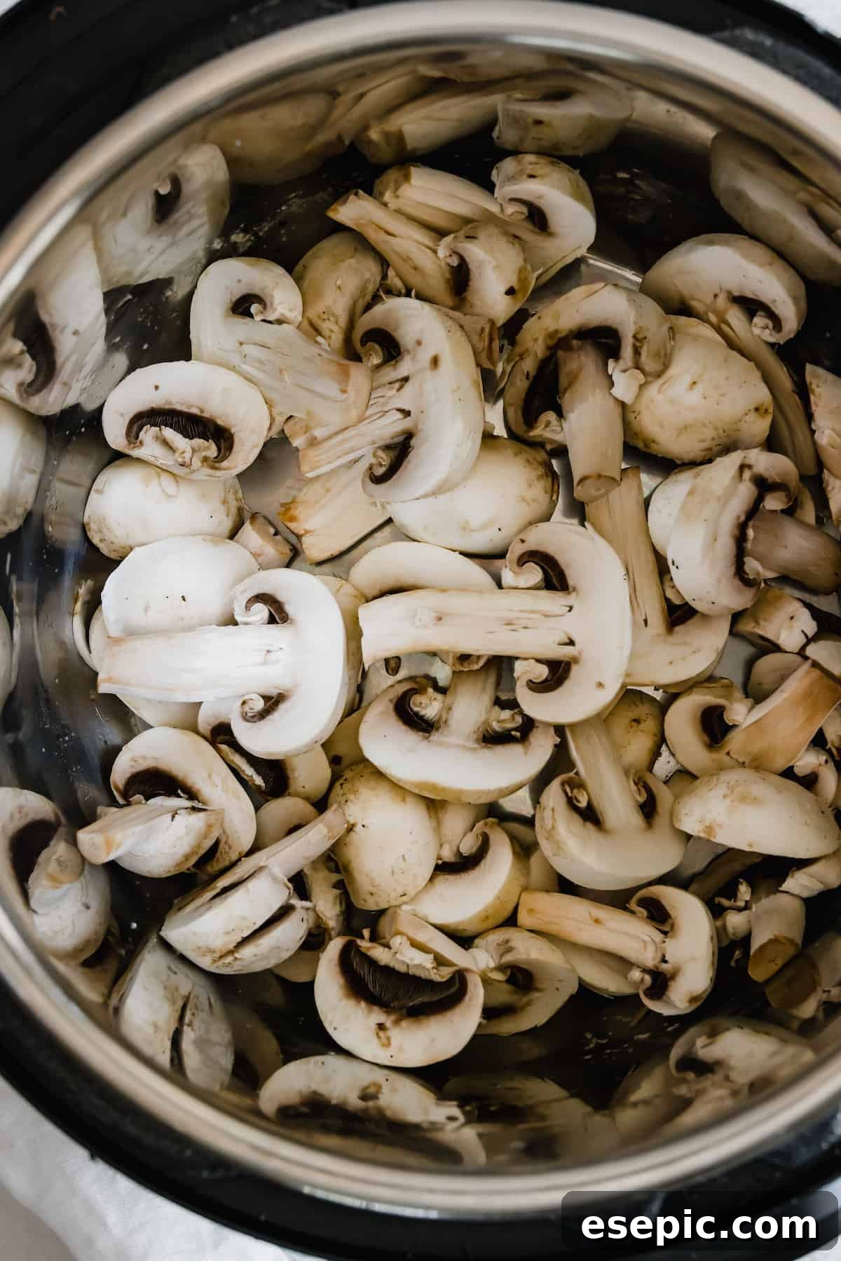 An Instant Pot Bowl Filled with Sliced Mushrooms