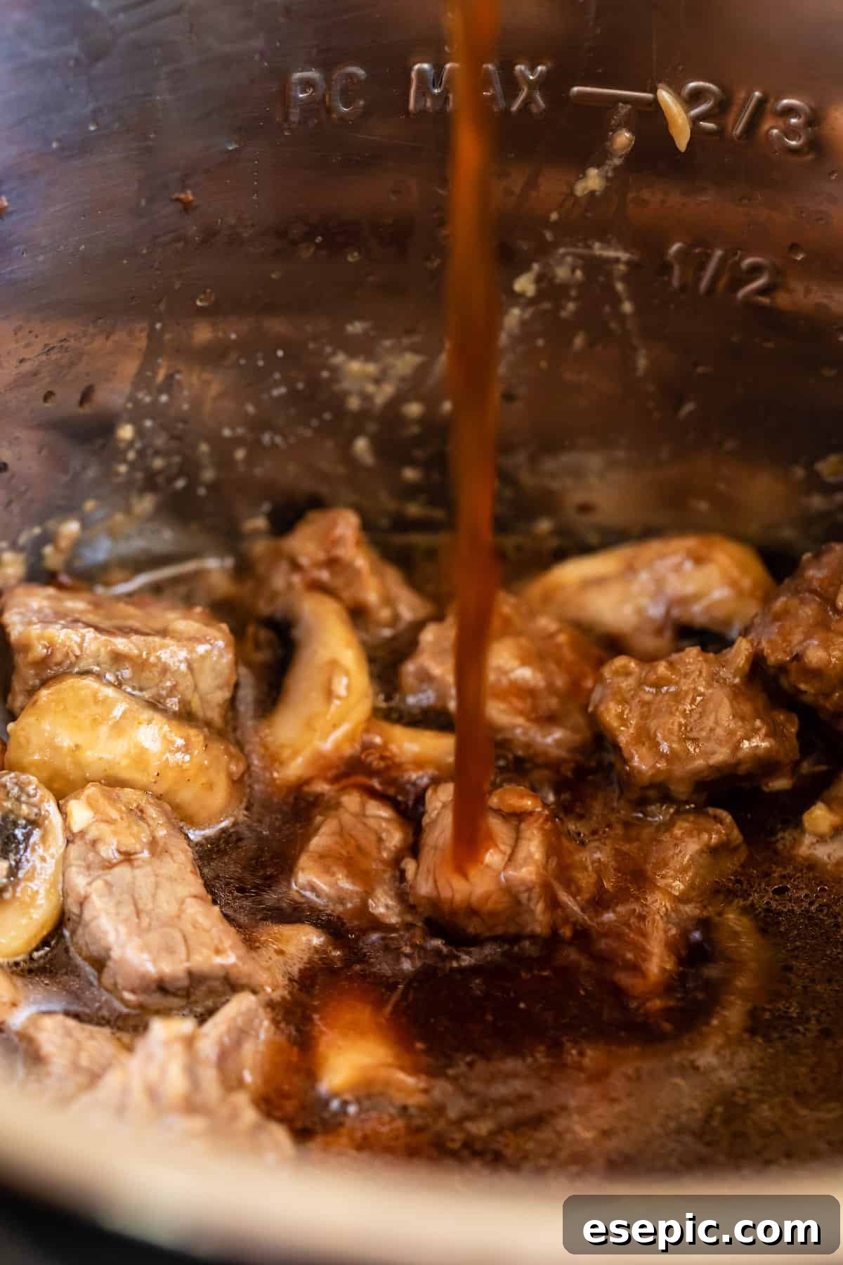 Beef Broth Being Added to the Instant Pot Bowl