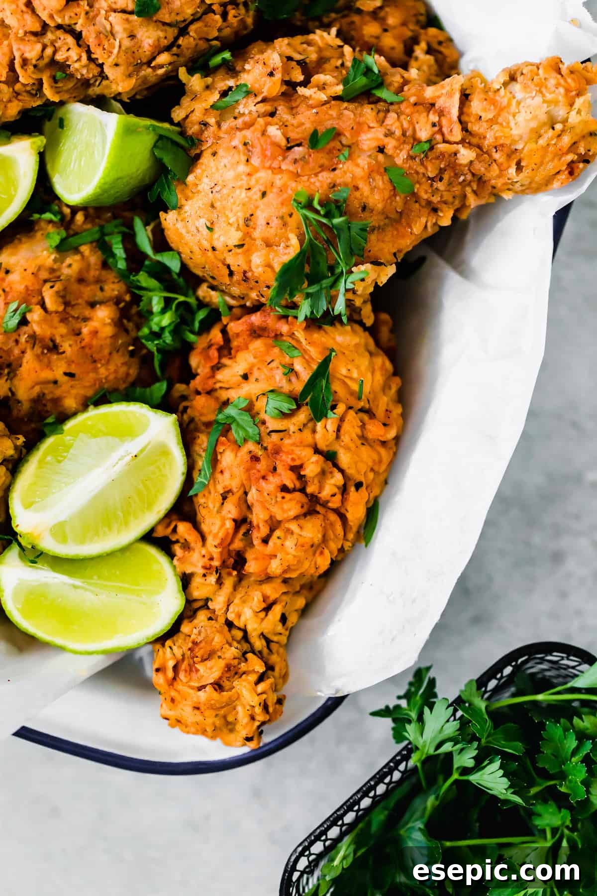 A Basked of Buttermilk Fried Chicken with Lime Wedges Inside