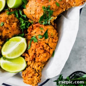 A Basked of Buttermilk Fried Chicken with Lime Wedges Inside