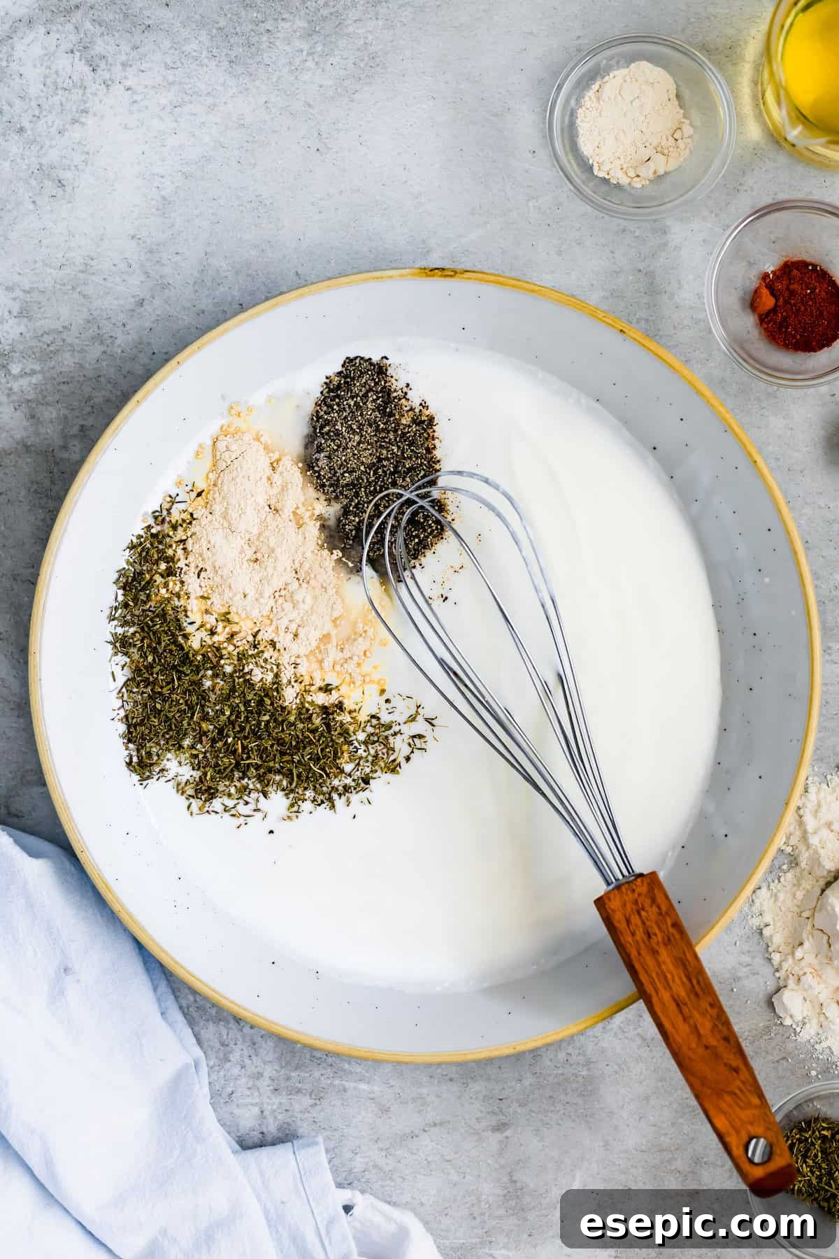 Buttermilk in a Bowl with Garlic Powder, Thyme, Salt and Pepper