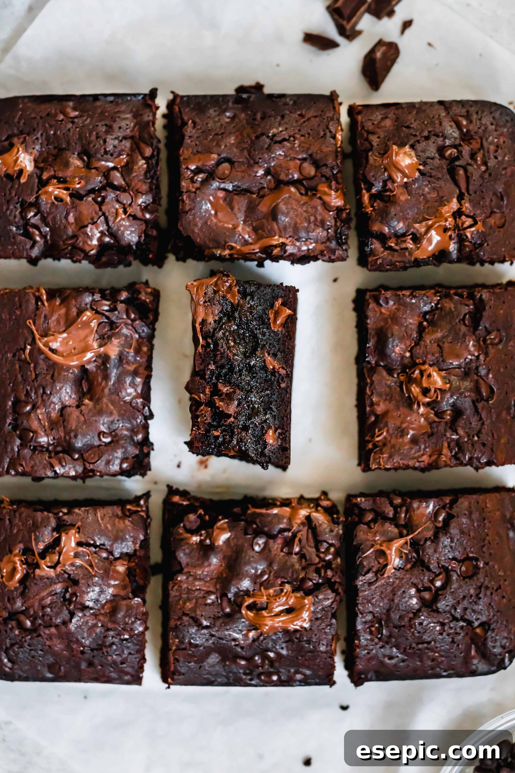 Nine Brownies Arranged in a Square with the Middle One on its Side, showing off their gooey centers and rich color