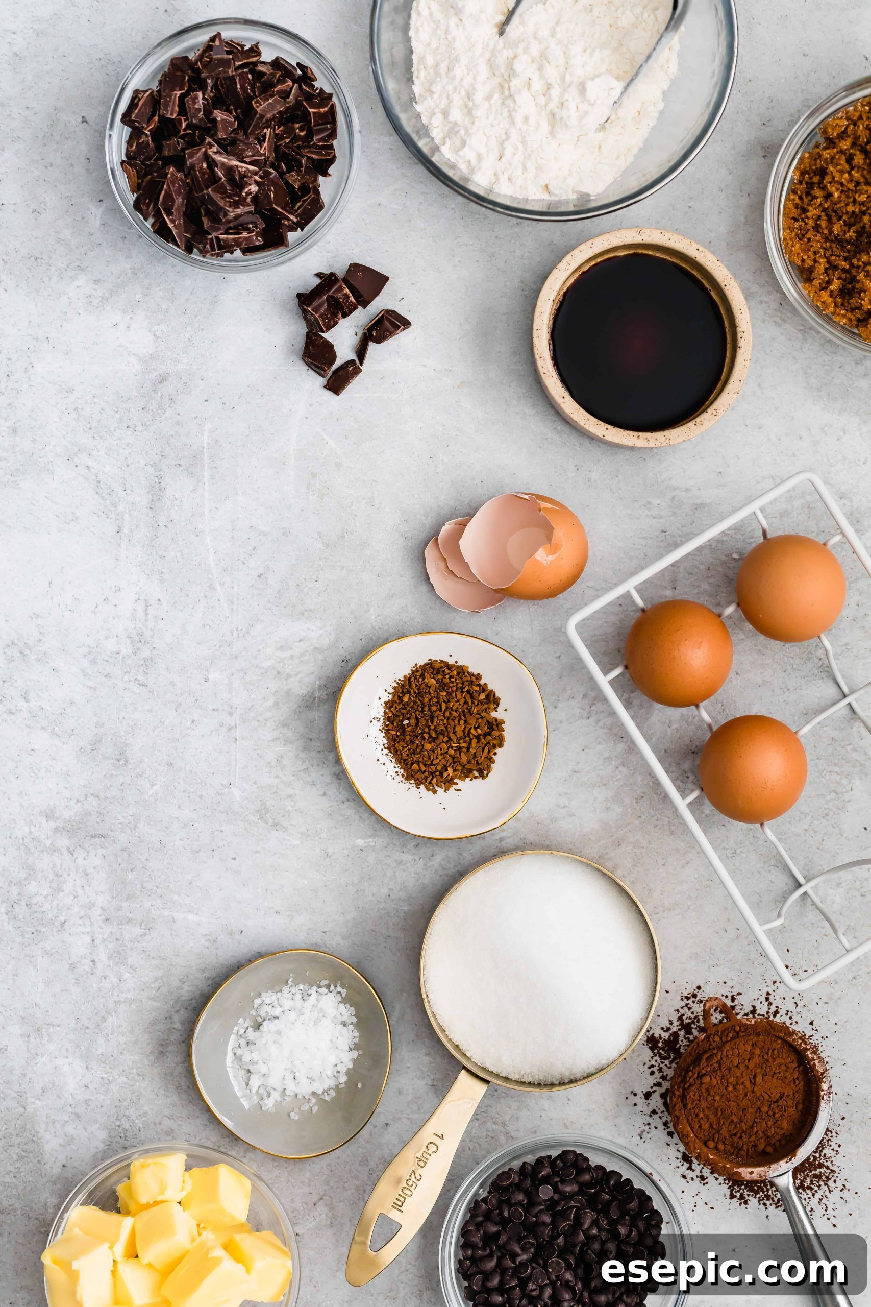 Sugar, Eggs, Chopped Dark Chocolate, and the Rest of the Brownie Ingredients on a Countertop, ready for baking