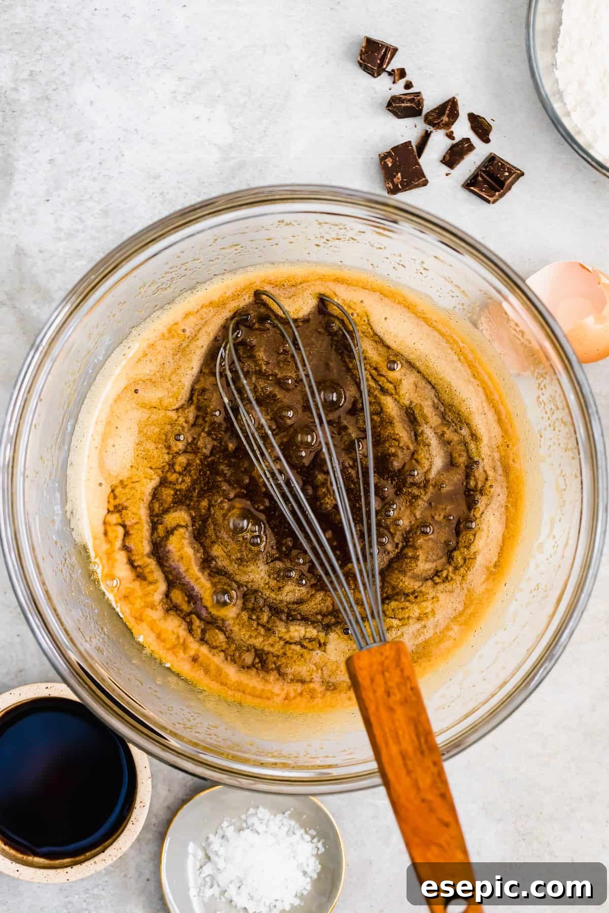Vanilla Extract Being Mixed Into a Bowl with the Other Wet Ingredients, creating a smooth, golden batter