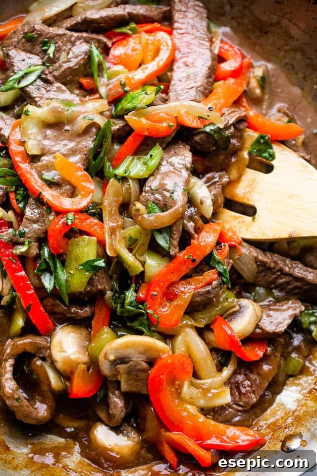 Sticky Honey Balsamic Beef 5 stirring through beef stir fry with vegetables