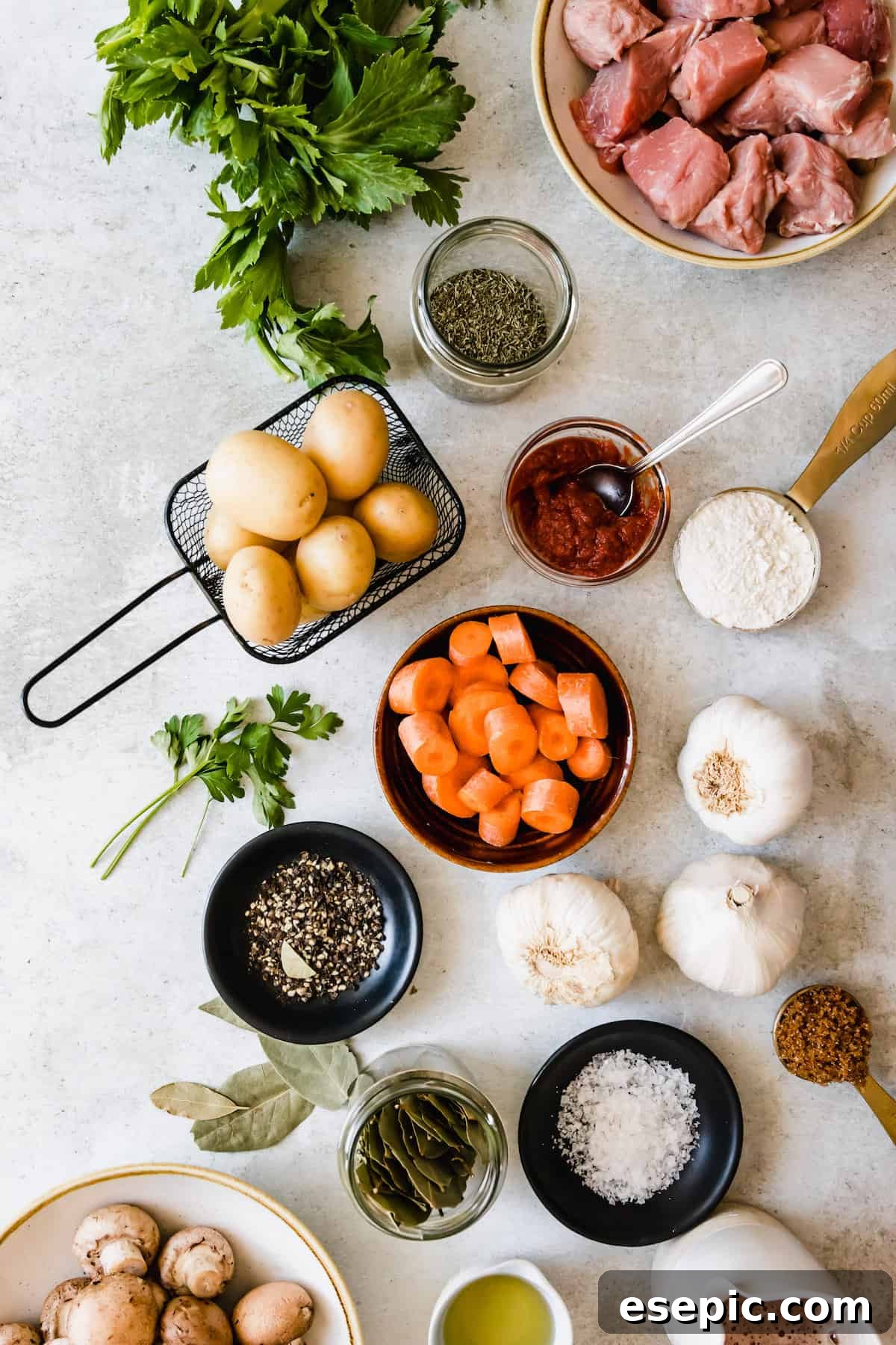 Slow-Simmered Guinness Beef Stew 4 A vibrant selection of fresh ingredients laid out for an Irish beef stew, including cubed beef, whole vegetables like carrots and potatoes, and aromatic herbs.