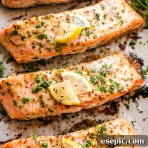 four baked maple mustard salmon fillets on a baking sheet