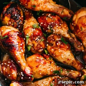 close up of chicken drumsticks glazed with honey sriracha sauce