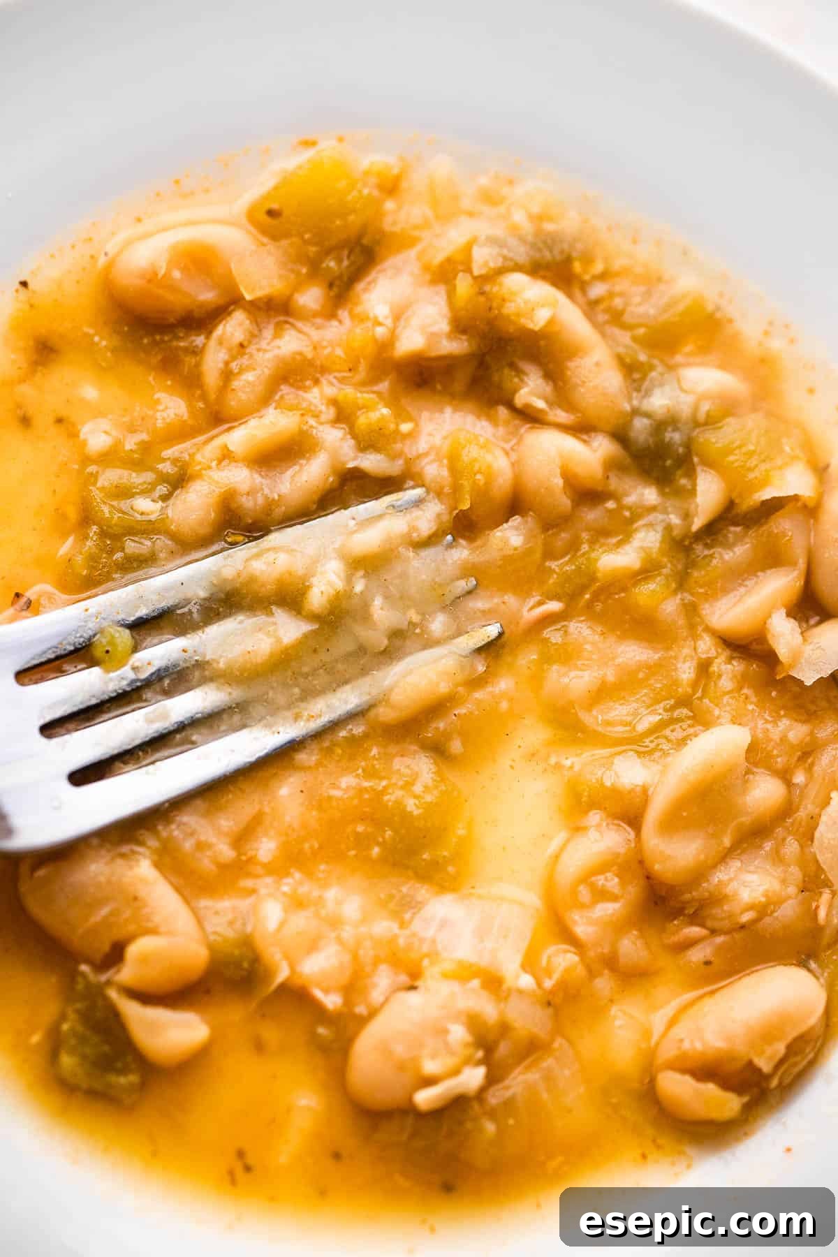 Hearty Chicken Chili 5 mashing beans with the back of a fork