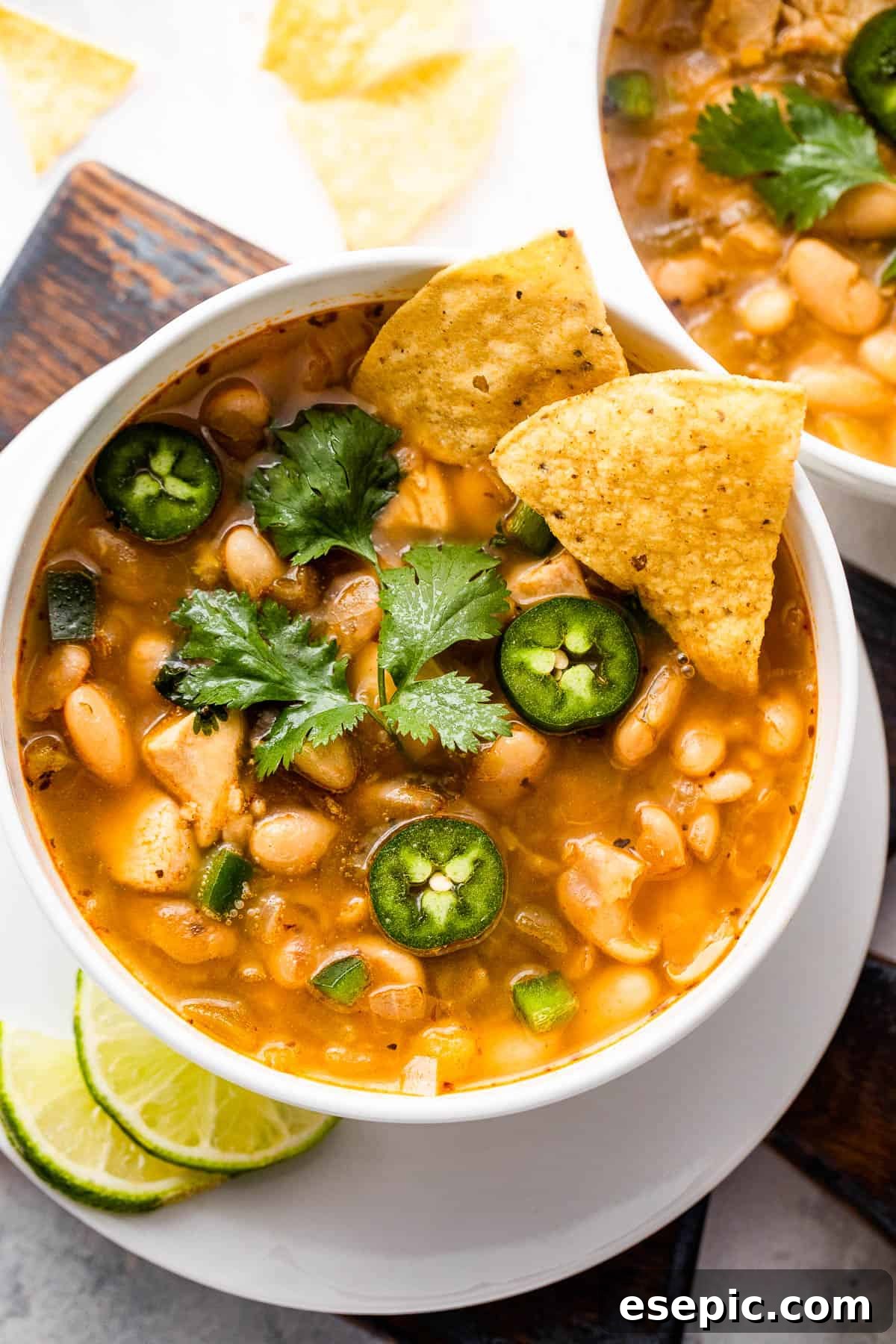 Hearty Chicken Chili 7 overhead shot of white soup bowls with chicken chili
