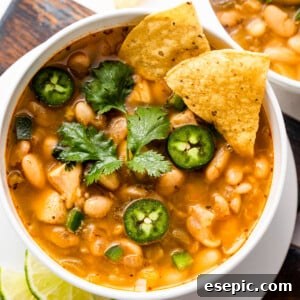 overhead shot of white soup bowls with chicken chili
