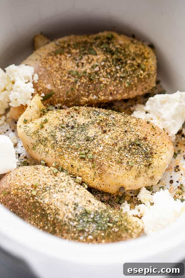 three seasoned raw chicken breasts