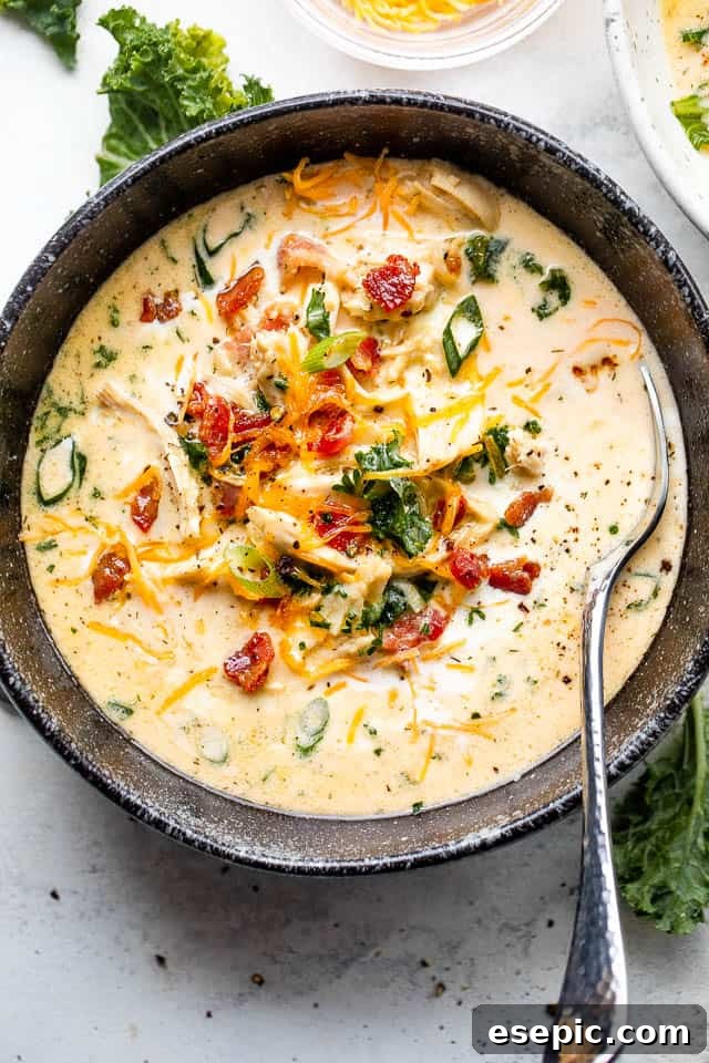 creamy crack chicken soup in a black bowl served with a spoon