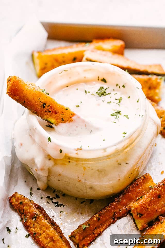 Zucchini fries dipped in a delicious sauce.