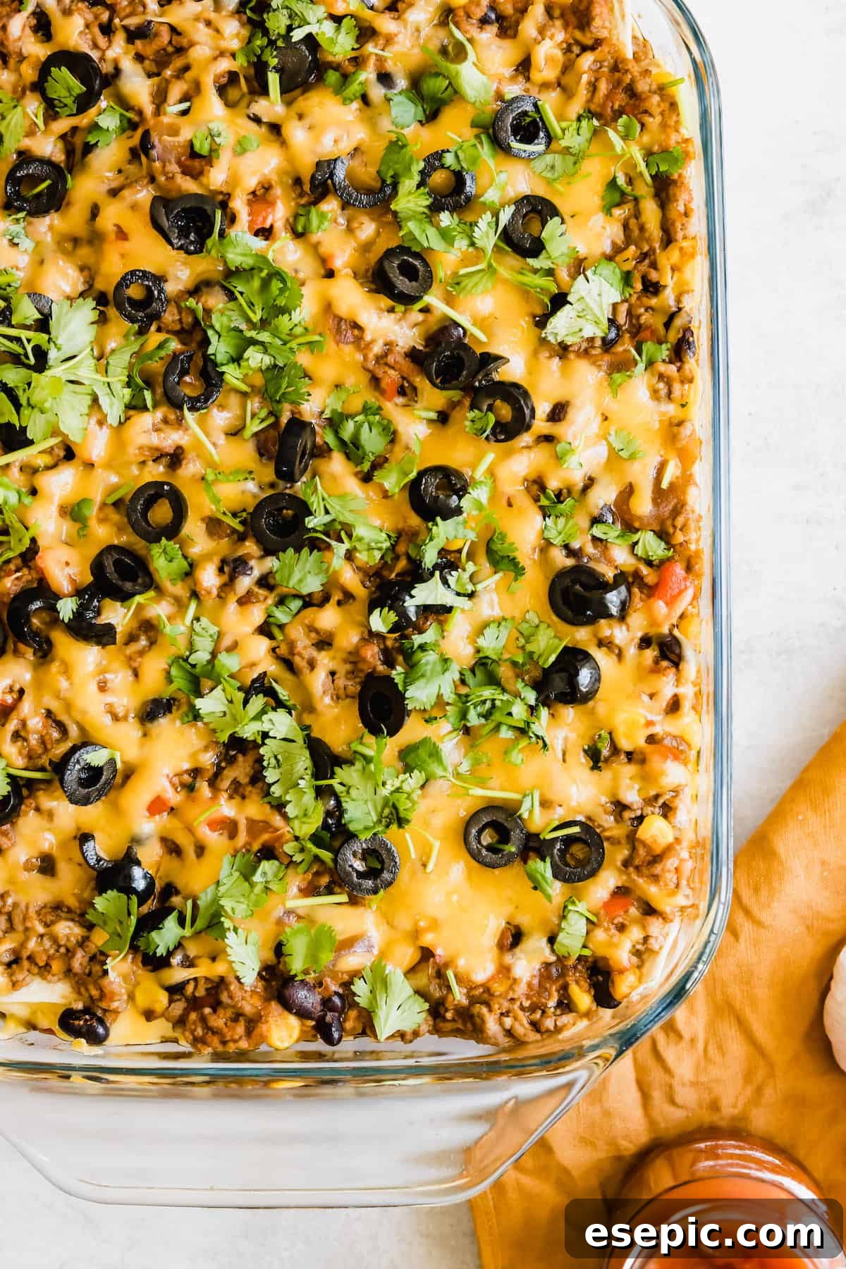 A Glass Casserole Dish Filled with Mexican Lasagna on a Countertop