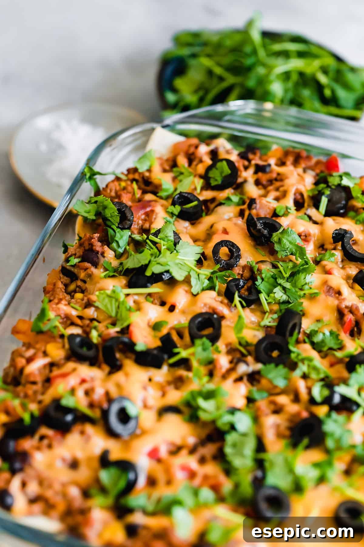 A Pan of Mexican Lasagna Topped with Chopped Parsley and Olives